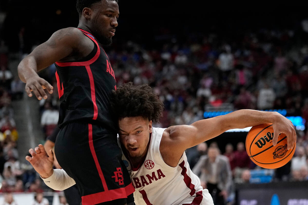 Alabama guard Mark Sears (1) runs into San Diego State guard Darrion Trammell (12) in the first ...