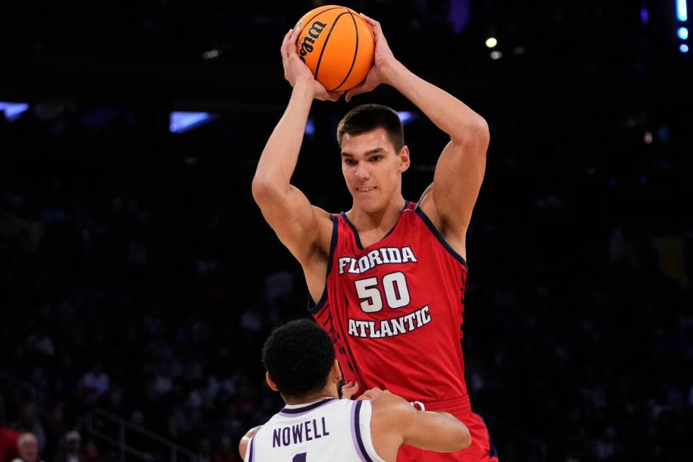 Florida Atlantic's Vladislav Goldin (50) grabs a rebound over Kansas State's Markquis Nowell (1 ...