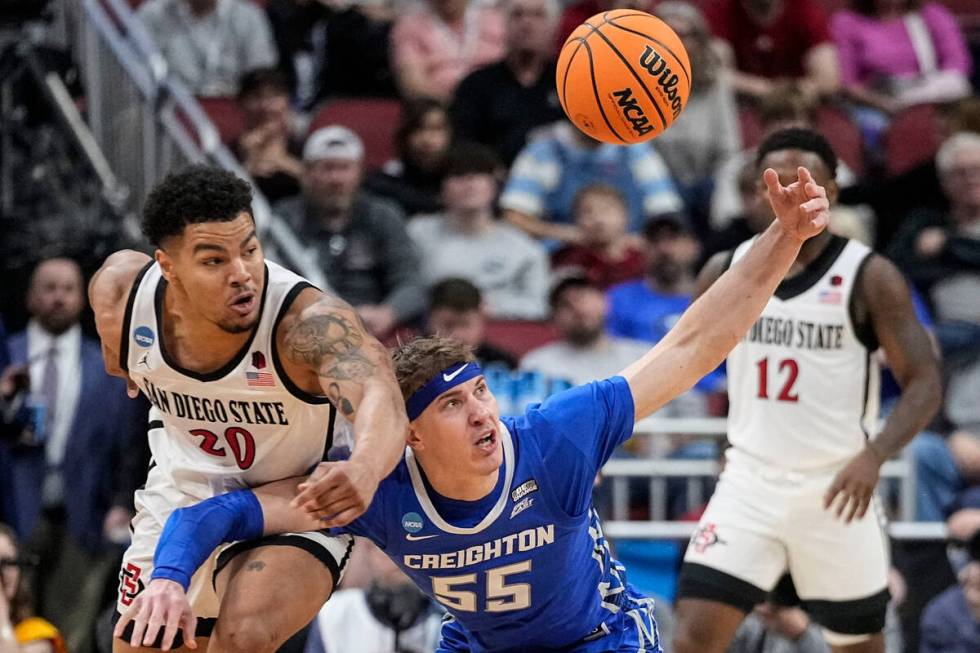 San Diego State guard Matt Bradley (20) and Creighton guard Baylor Scheierman (55) vie for a lo ...