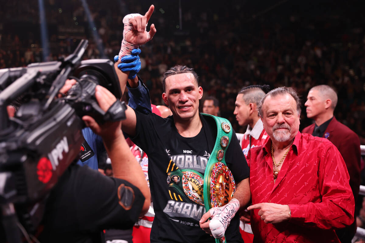 David Benavidez, center, raises his hand after his unanimous decision victory against Caleb Pla ...