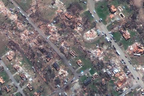 This satellite image provided by Maxar Technologies shows destroyed homes along Walnut and Mulb ...