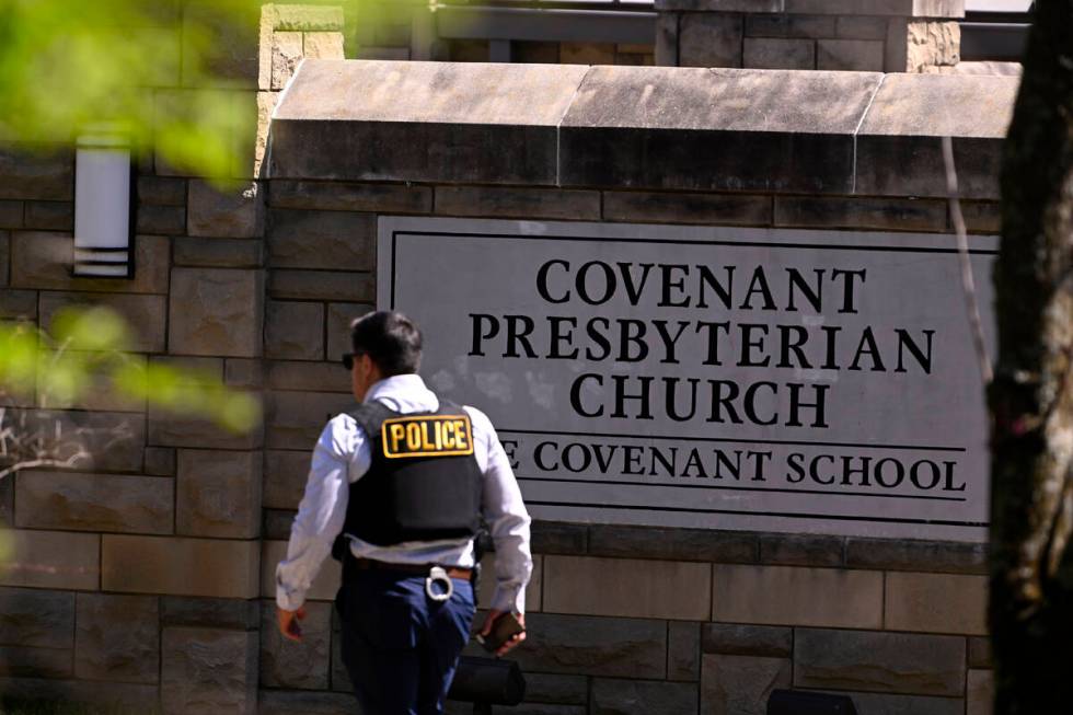 A police officer walks by an entrance to The Covenant School after a shooting in Nashville, Ten ...
