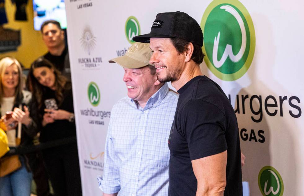 Brothers Paul Wahlberg, left, and Mark Wahlberg pose for pictures during the opening celebratio ...