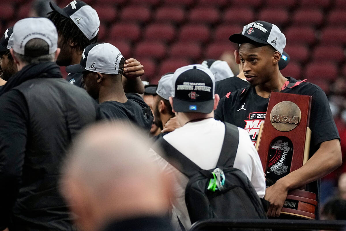 San Diego State players celebrate with the trophy after a Elite 8 college basketball game betwe ...