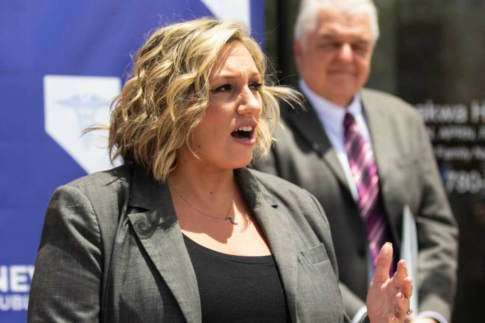 State Majority Leader Nicole Cannizzaro speaks as Gov. Steve Sisolak looks on, on Wednesday, Ju ...