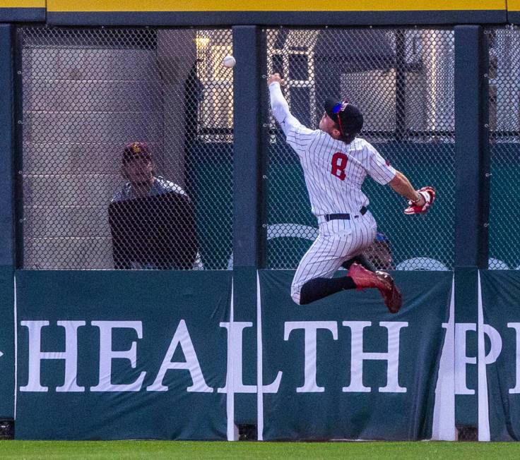 UNLV outfielder Santino Panaro (8) misses a fly ball on the fence against Arizona State during ...