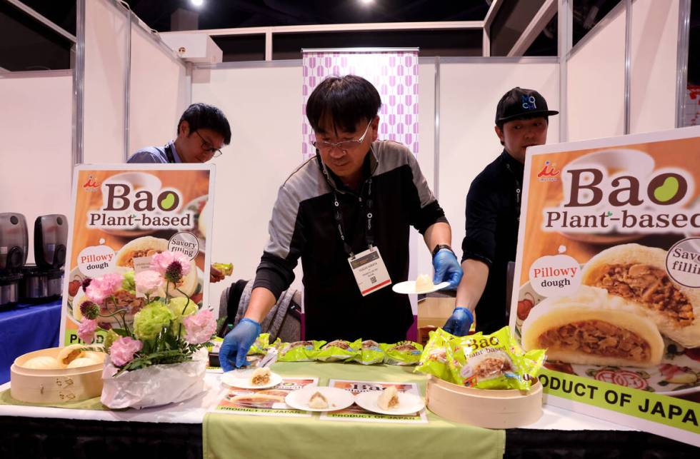 Yuichi Hirata, vice president at Imuraya USA, gives out samples of plant based bao at the Bar & ...