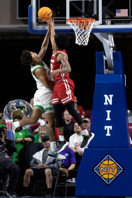 North Texas Mean Green guard Kai Huntsberry (10) shoots while Wisconsin Badgers guard Chucky He ...