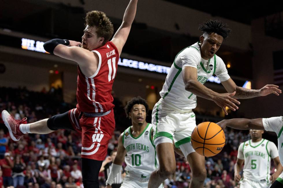 North Texas Mean Green guard Aaron Scott (1) blocks a shot by Wisconsin Badgers guard Max Klesm ...