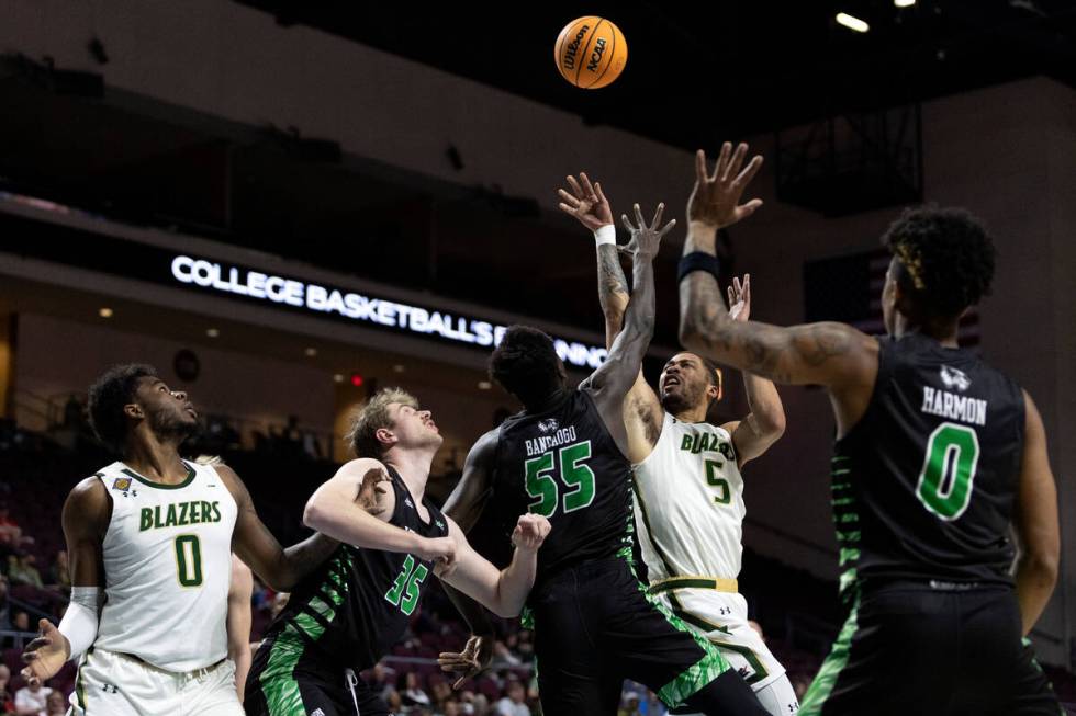 UAB Blazers forward KJ Buffen (5) shoots against Utah Valley Wolverines center Aziz Bandaogo (5 ...