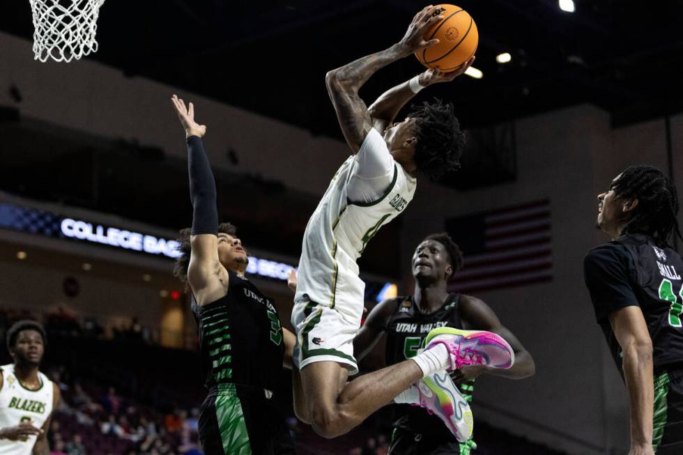 UAB Blazers guard Eric Gaines (4) shoots against Utah Valley Wolverines guard Blaze Nield (3) a ...