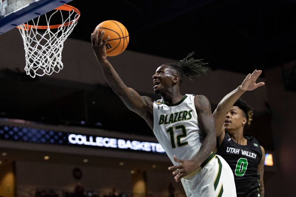 UAB Blazers guard Tony Toney (12) shoots against Utah Valley Wolverines guard Justin Harmon (0) ...