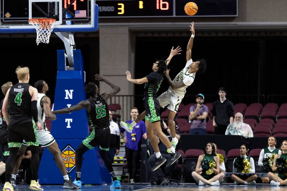 UAB Blazers guard Eric Gaines (4) shoots against Utah Valley Wolverines guard Tahj Small (11) d ...