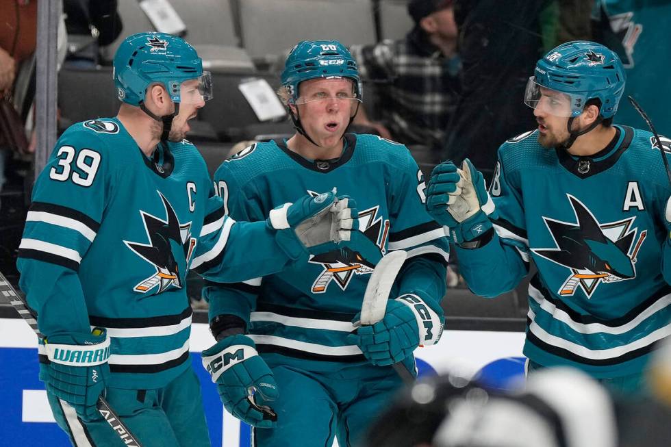 San Jose Sharks left wing Fabian Zetterlund, center, and Logan Couture (39) congratulate Mario ...