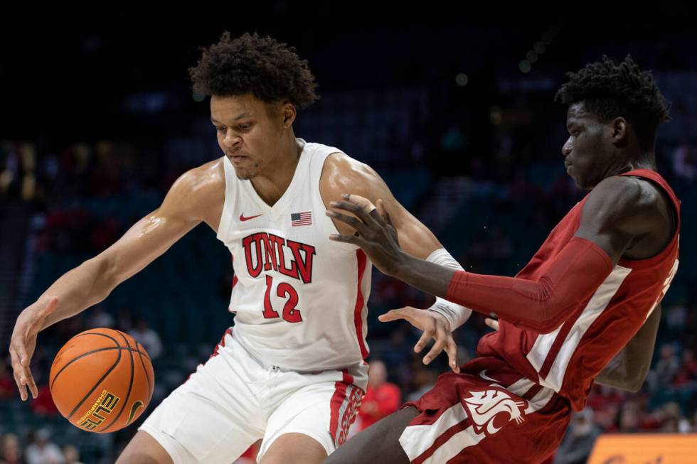 UNLV Rebels center David Muoka (12) pushes Washington State Cougars forward Mouhamed Gueye, rig ...