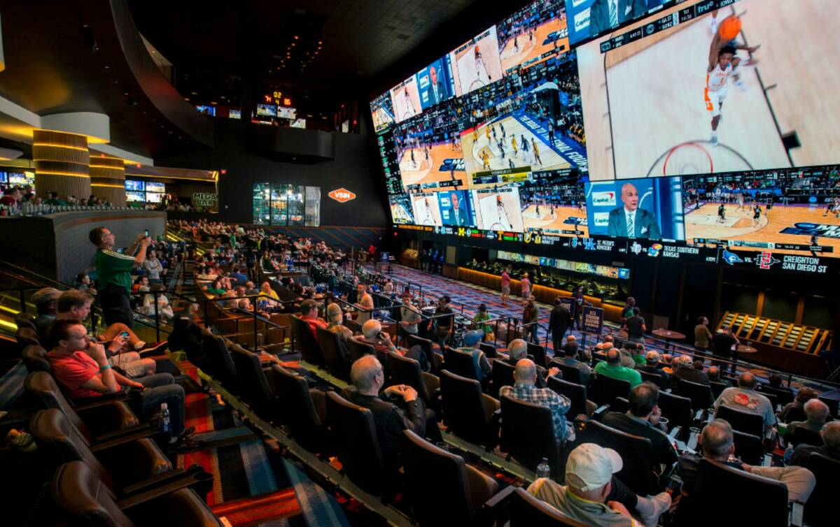 Fans watch games during March Madness at the Circa Sportsbook in March 2022 in Las Vegas. (Bizu ...