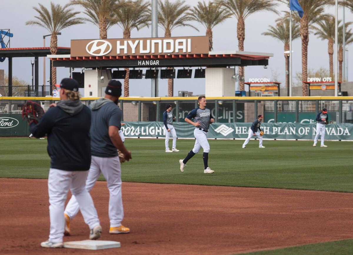 Las Vegas Aviators pitcher Jack Cushing, center, works out as players practice during media day ...
