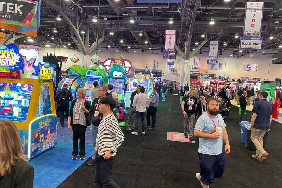 Attendees roam the exhibit hall during the Amusement Expo International on Tuesday, March 28, 2 ...