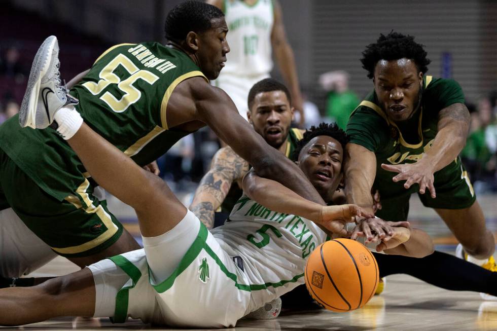 North Texas Mean Green guard Tylor Perry (5) dives to keep possession on offense while UAB Blaz ...