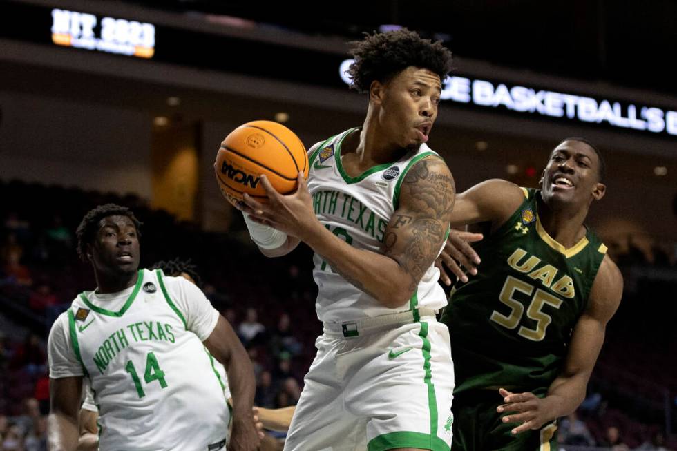 North Texas Mean Green guard Kai Huntsberry (10) secures the rebound on a shot by UAB Blazers c ...