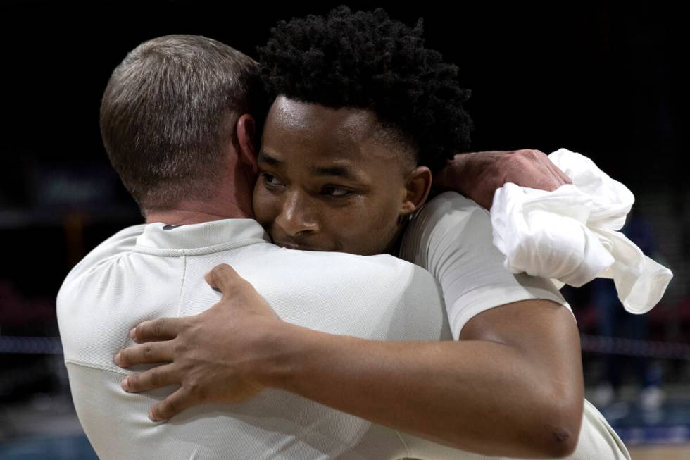 North Texas Mean Green guard Tylor Perry hugs associate head coach Ross Hodge after their team ...