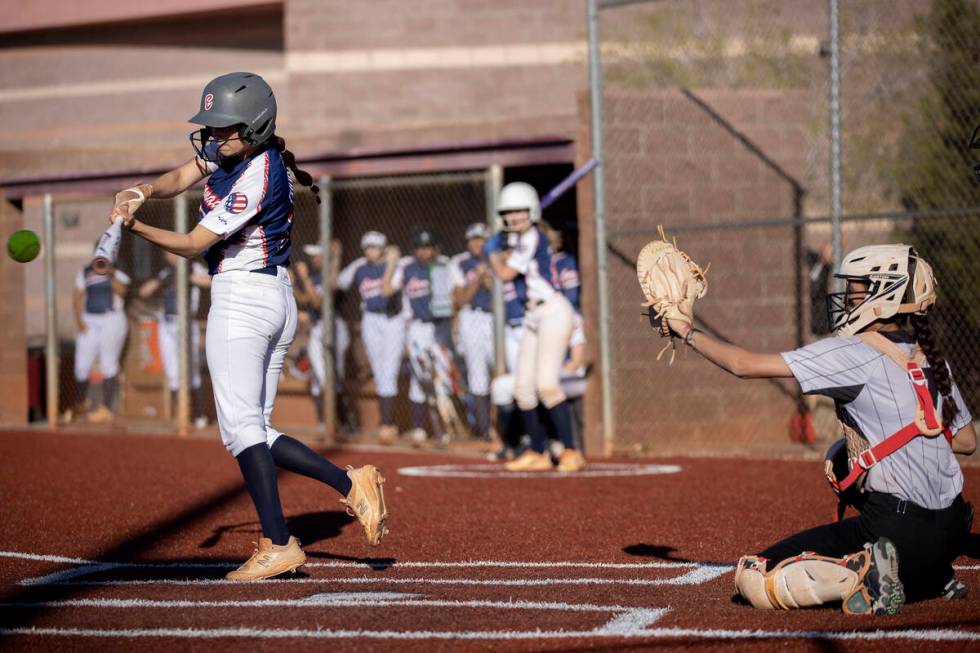 Coronado’s Paisley Magdaleno swings to hit while Faith Lutheran’s Jillian Molnar ...