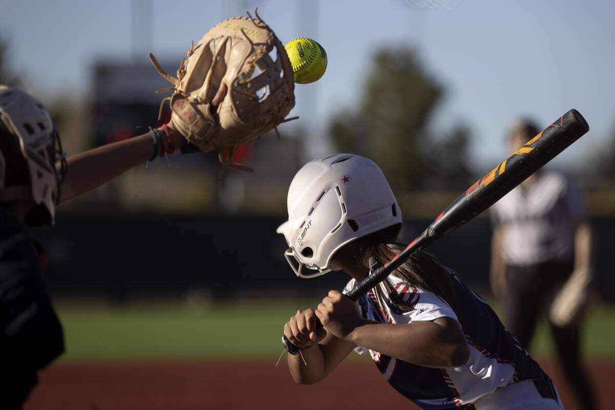 Faith Lutheran’s Jillian Molnar reaches to catch while Coronado’s Summer Gilliam ...