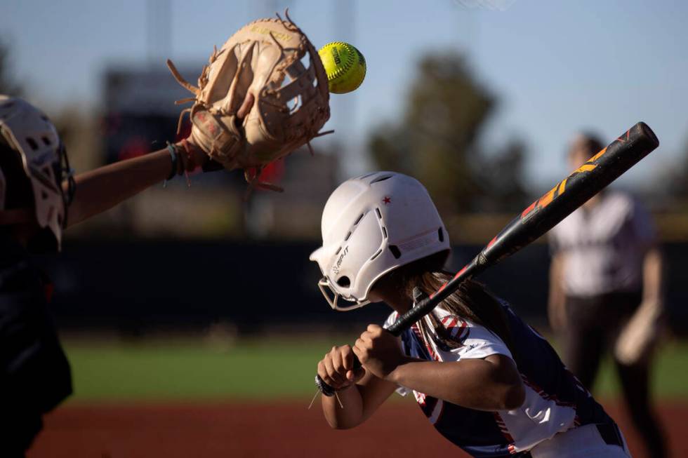 Faith Lutheran’s Jillian Molnar reaches to catch while Coronado’s Summer Gilliam ...