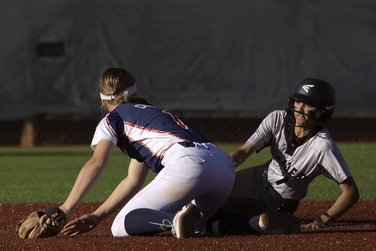 Faith Lutheran’s Jillian Molnar (7), right, is safe at second base next to Coronado’s Mayra ...