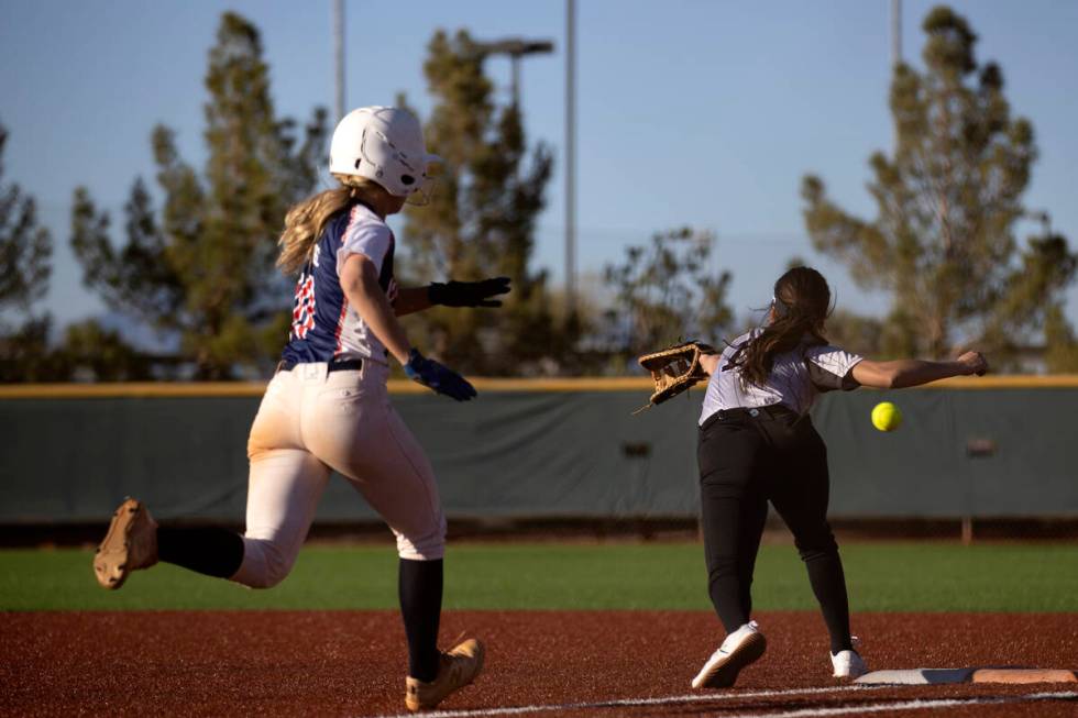 Coronado’s Charlotte Bendlin is almost to first base while Faith Lutheran’s Averi ...