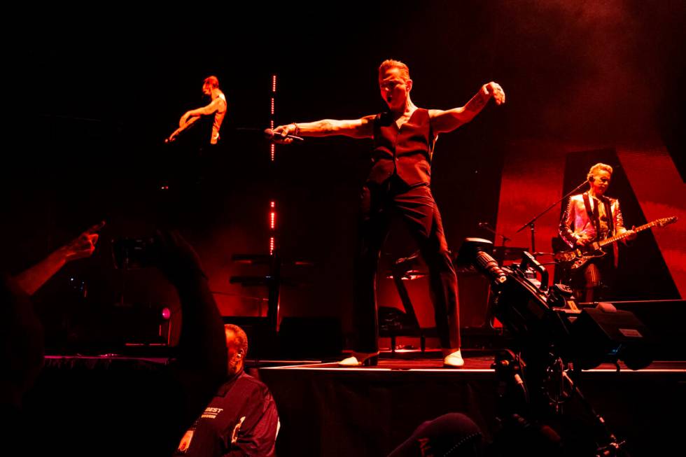 Dave Gahan, center, and Martin Gore, right, of Depeche Mode perform at T-Mobile Arena on Thursd ...