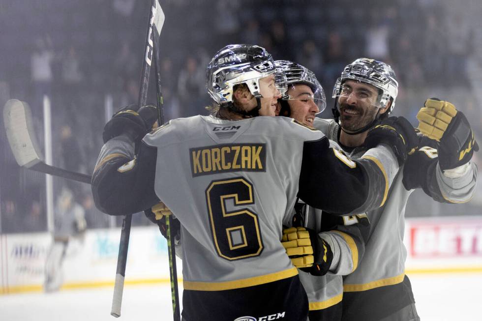 Henderson Silver Knights defenseman Kaedan Korczak (6), forward Brendan Brisson, center, and de ...