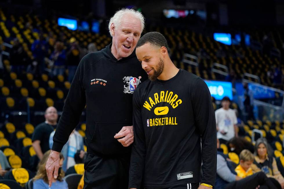 Hall of Fame basketball player Bill Walton, left, talks with Golden State Warriors guard Stephe ...