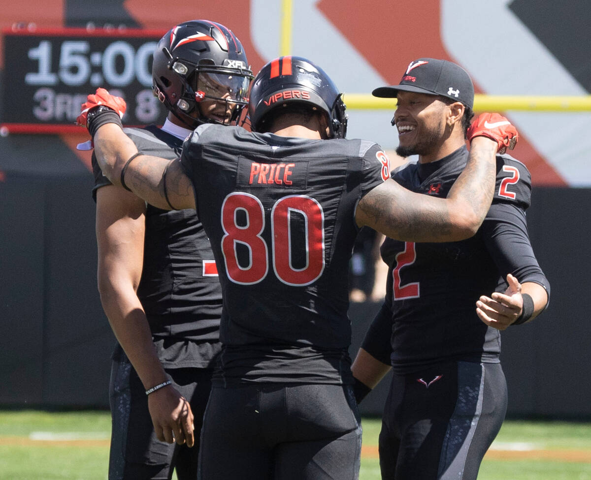 Vegas Vipers tight end Sean Price (80) speaks with Vegas Vipers quarterback Jalan McClendon (3) ...