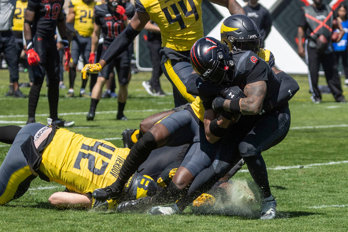 Vegas Vipers running back John Lovett (8) is tackled by San Antonio Brahmas defensive lineman M ...