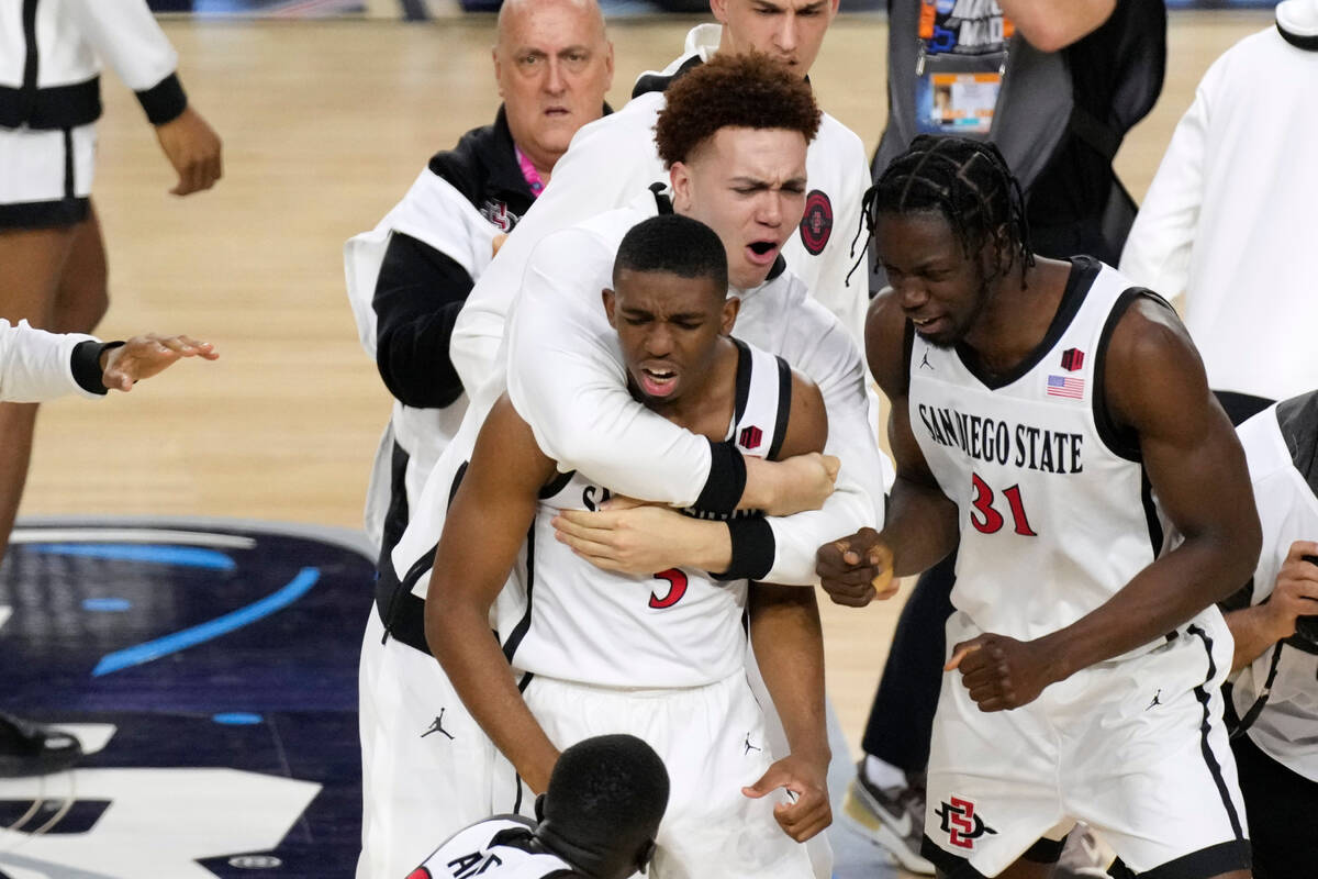 San Diego State guard Lamont Butler (5) celebrates with teammates after he hit the winning bask ...