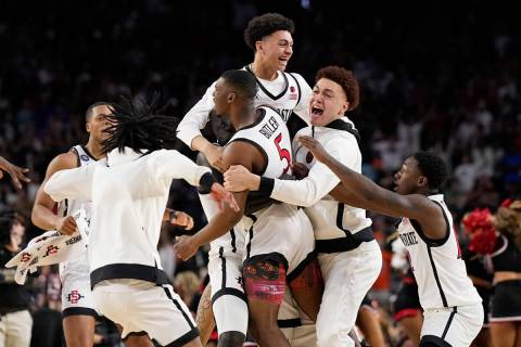 San Diego State guard Lamont Butler (5) celebrates with teammates after scoring the winning bas ...