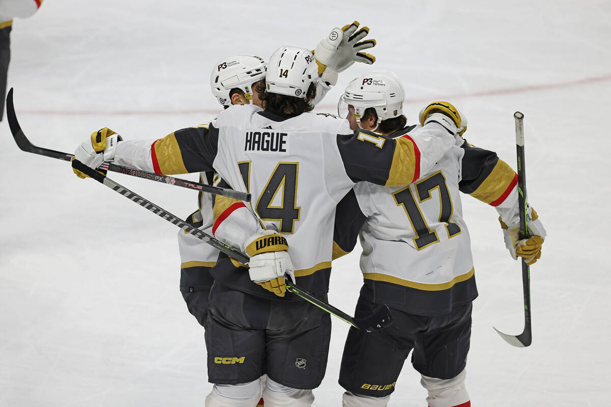 Vegas Golden Knights defenseman Ben Hutton (17) celebrates with teammates after scoring a goal ...