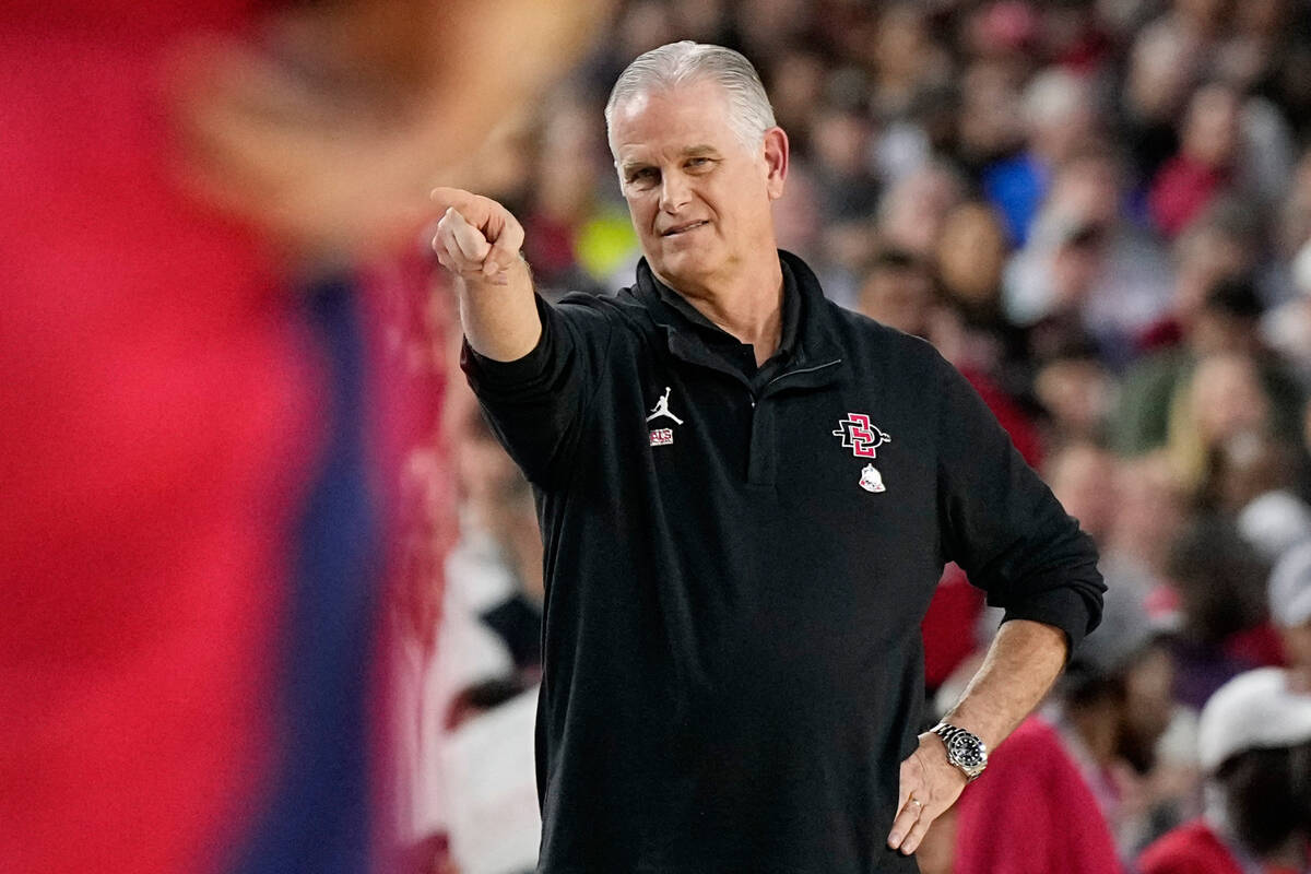 San Diego State head coach Brian Dutcher points during the first half of a Final Four college b ...