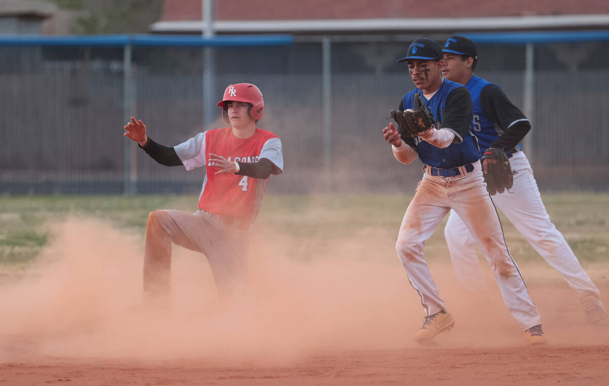 Doral Academy's Kainoa Paul (4) gets to second base against Desert Pines' Jose Zamora (1) durin ...