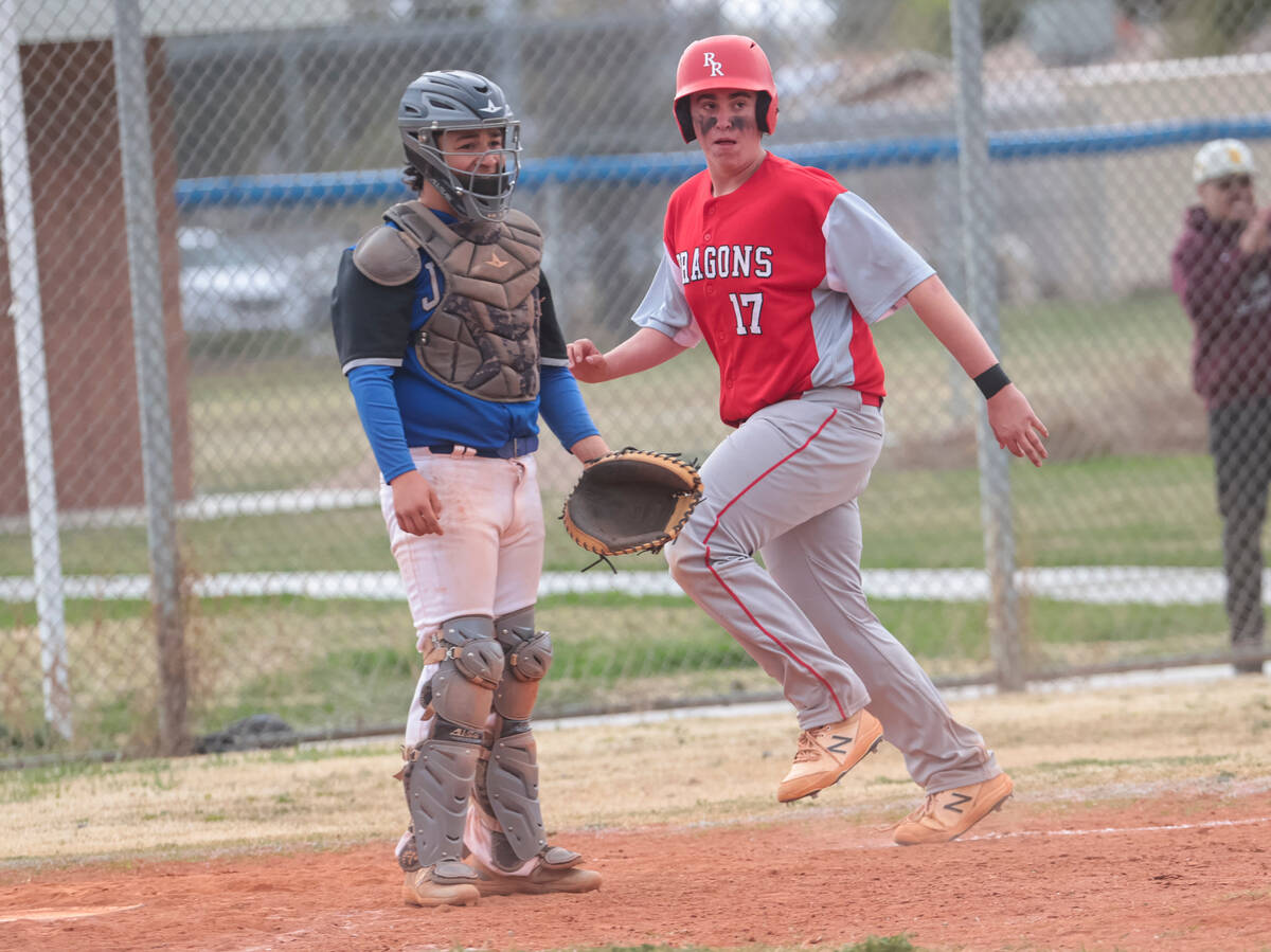 Doral Academy's Logan Olivier (17) scores a run against Desert Pines during a baseball game at ...