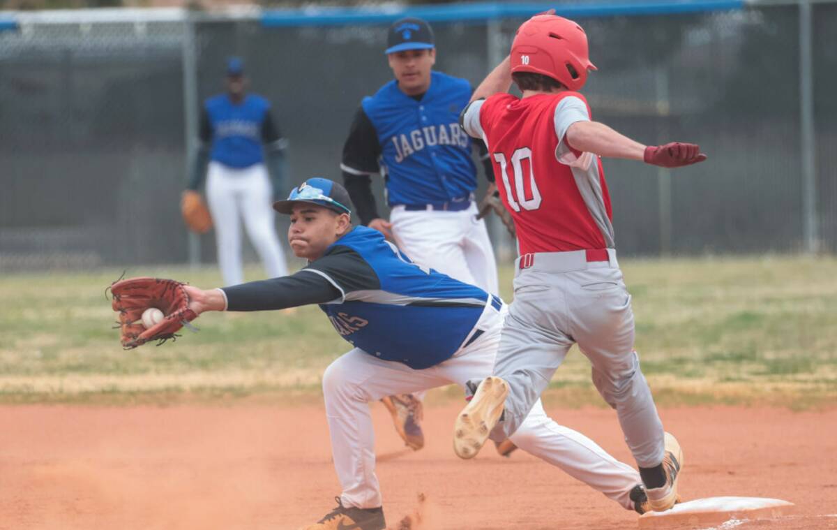Desert Pines' Eric Milian (14) forces out Doral Academy's Maddox Fikkert (10) during a baseball ...