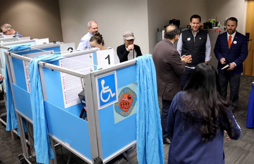 Nevada Secretary of State Cisco Aguilar, second from right, and Mark Wlaschin, deputy secretary ...