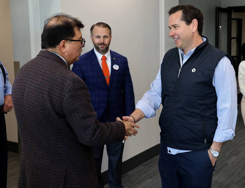 Nevada Secretary of State Cisco Aguilar, right, greets Henderson City Clerk Jose Luis Valdez as ...