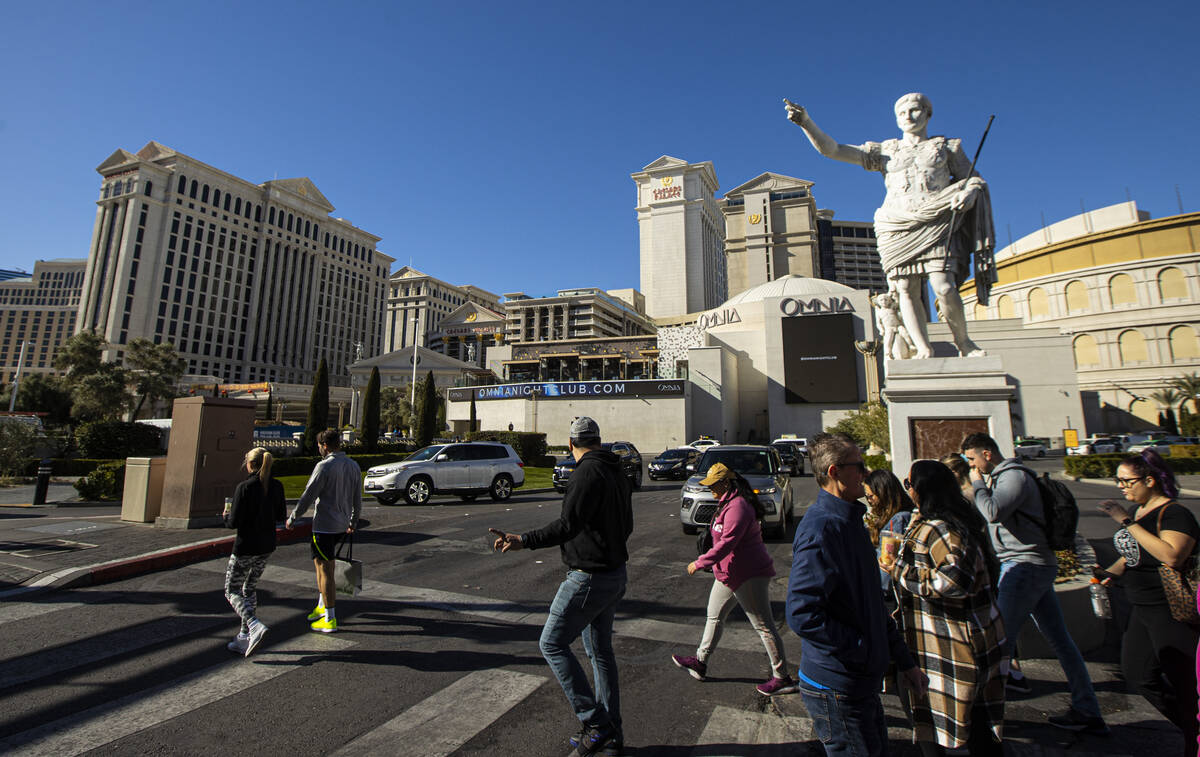 Pedestrians walk along the Strip outside Caesars Palace on Jan. 26, 2023, in Las Vegas. (Chase ...