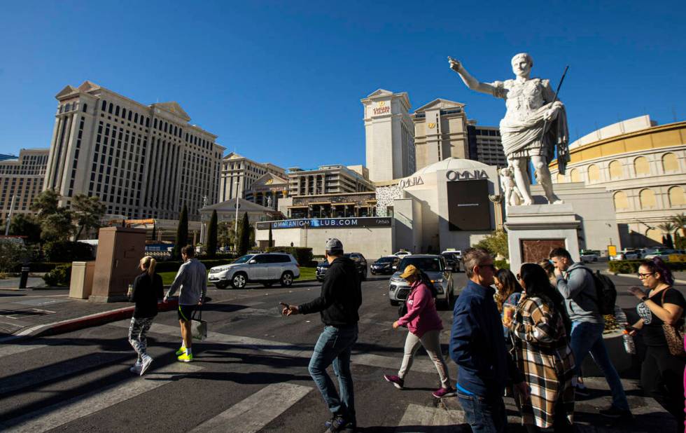 Pedestrians walk along the Strip outside Caesars Palace on Jan. 26, 2023, in Las Vegas. (Chase ...