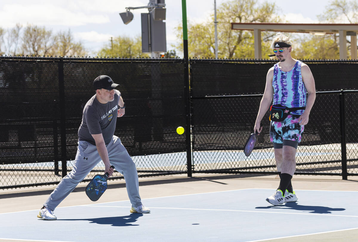 Steve Beckwith, of Henderson, left, and Cliff Walls, of Las Vegas, play pickleball at the Sunse ...