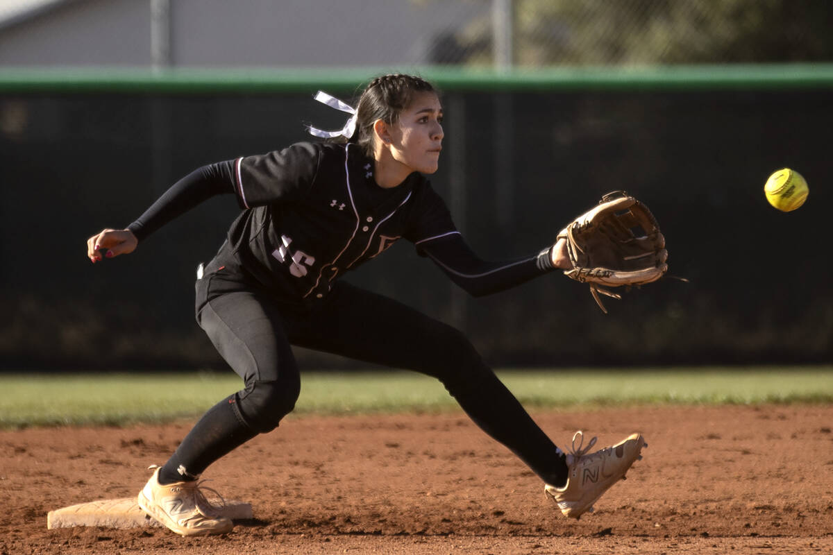 Faith Lutheran’s Shaylee Ghadery reaches to catch at second base during a high school so ...