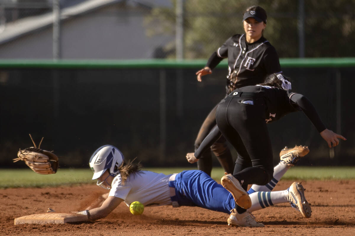 Green Valley’s Lauryn Galvin steals second base while Faith Lutheran’s Shaylee Gh ...