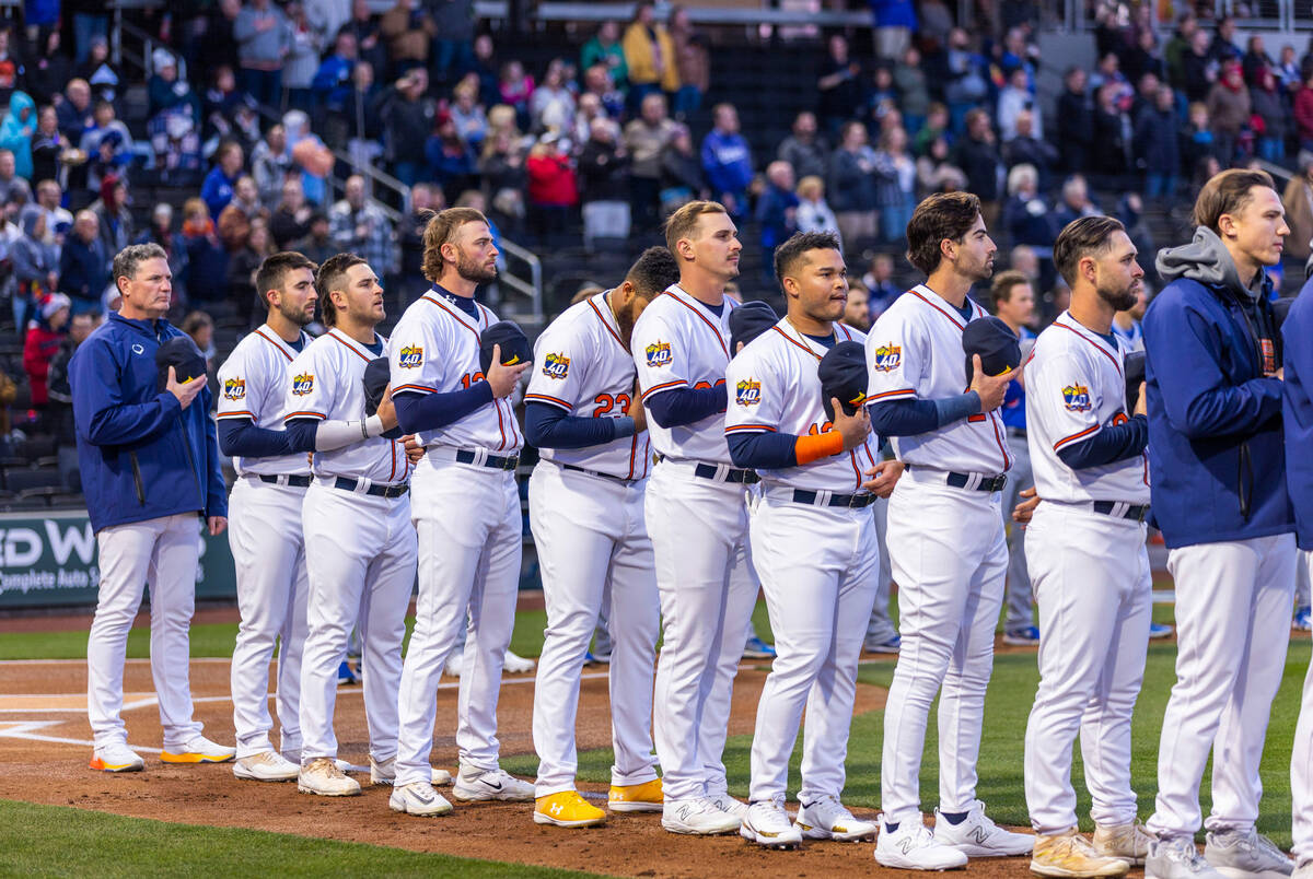 Starting Aviators with Manager Fran Riordan, left, stand for the National Anthem before facing ...